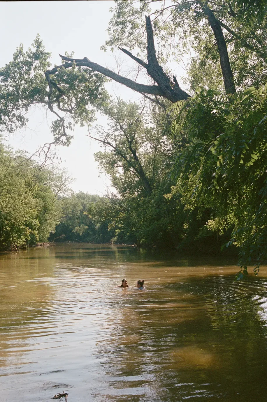 Two people swimming in the red river in celebration of their wedding anniversary